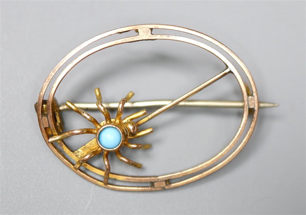 A 9ct and turquoise set oval openwork spider brooch, 25mm, gross 1.7 grams.
